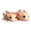 Two pale pink articulated axolotl figures lying side by side, shown from the front with their gills and dark eyes visible.
