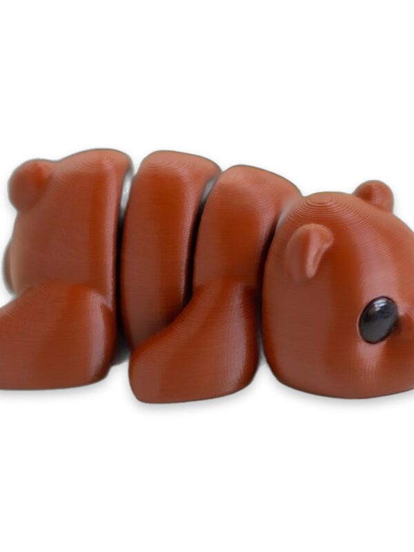 articulated-baby-bear-fidget-toy-poseable-desk-buddy-1 A white and a red-brown articulated bear figure lying side by side on a white background.