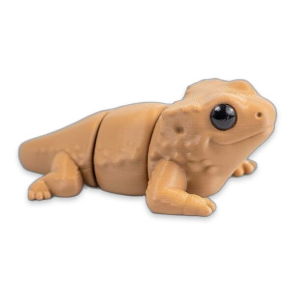 Tan articulated bearded dragon figure lying with legs bent, shown from the side.