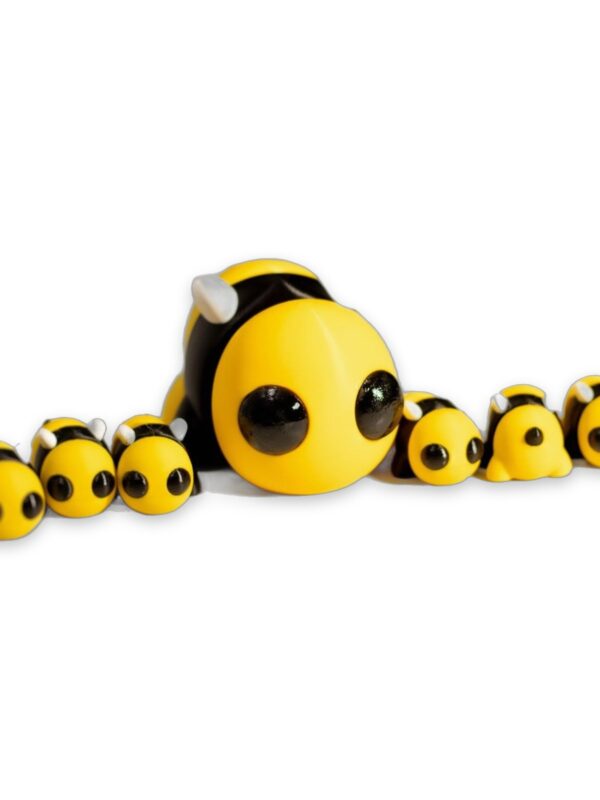 articulated-baby-bee-fidget-toy-poseable-desk-buddy-1 A large articulated bee figure surrounded by five smaller bee figures of the same design, all with big black eyes and yellow and black bodies.