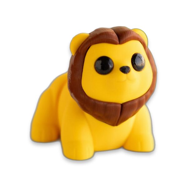 articulated-baby-lion-fidget-toy-poseable-desk-buddy-1 A yellow 3D printed baby lion figure with a brown mane sits on a table.