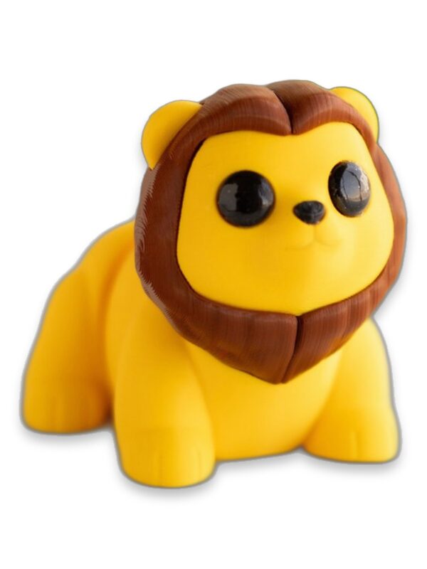articulated-baby-lion-fidget-toy-poseable-desk-buddy-1 A yellow 3D printed baby lion figure with a brown mane sits on a table.