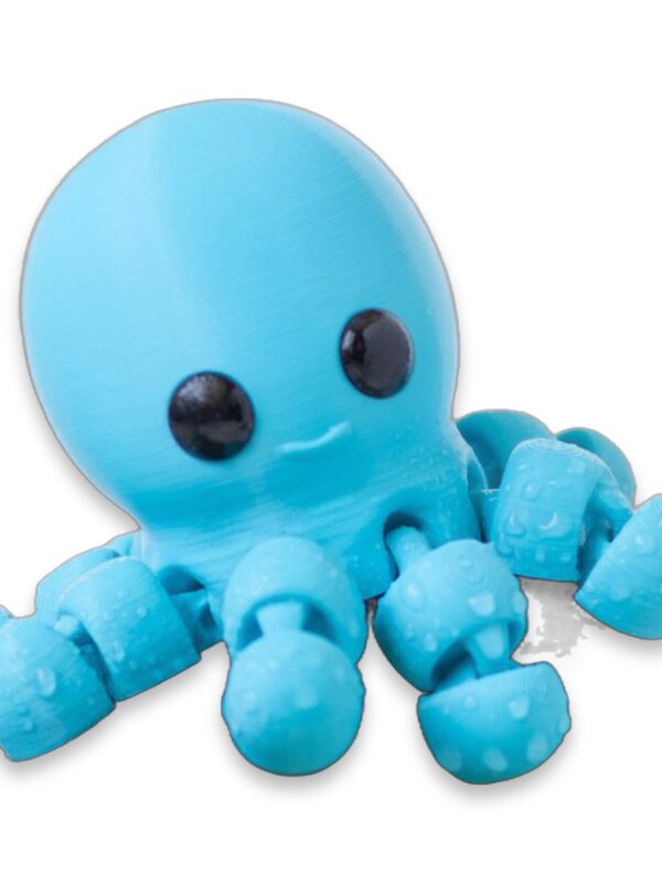 articulated-baby-octopus-fidget-toy-1 Blue articulated baby octopus figure perched on a dark rock among green leaves, with two more octopus figures blurred in the background.
