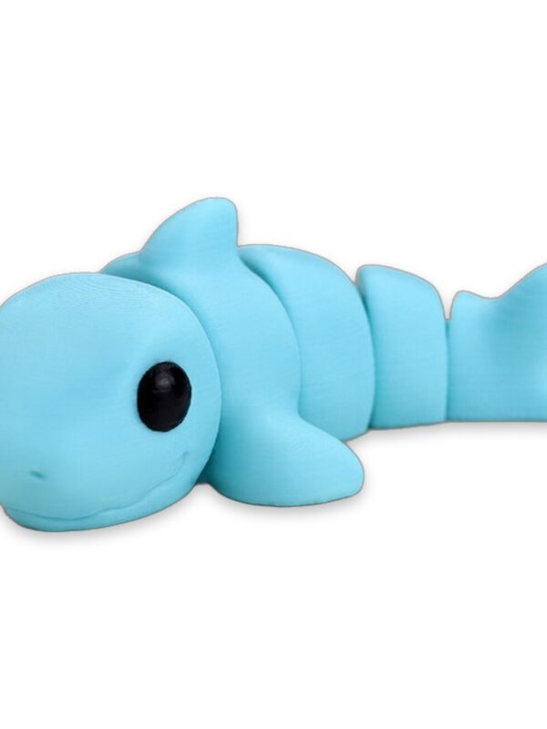 articulated-baby-shark-fidget-toy-poseable-desk-buddy-1 A light blue articulated baby shark figure lying on its side on a white background, with the words Baby Shark beneath it.