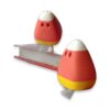 A pink and yellow candy corn figure with poseable legs standing on a miniature book, next to a second figure.