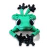articulated-frog-3d-printed-flexi-posable-3 Front view of a green articulated frog figurine perched on the edge of a green marble slab, feet dangling over the side.