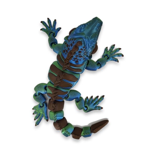 articulated-iguana-3d-printed-3 Teal and green articulated iguana figure viewed from above with front legs raised and tail curled.