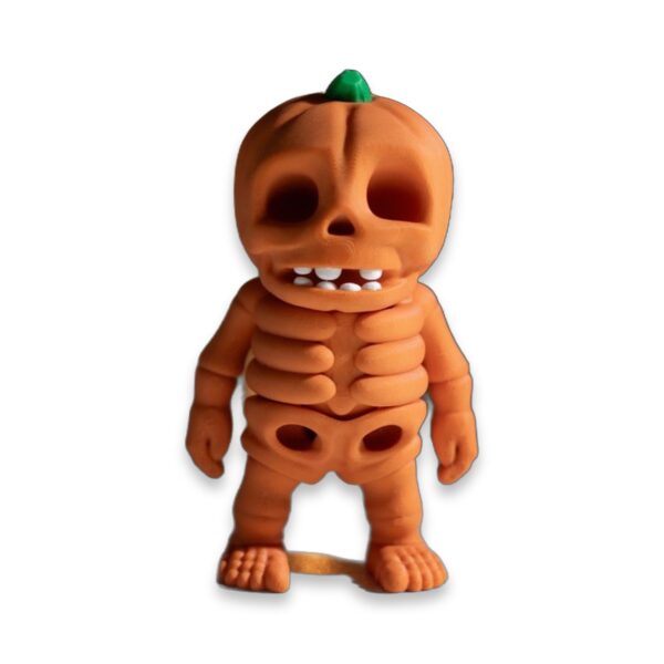 articulated-pumpkin-skeleton-fidget-toy-poseable-desk-buddy-2 Side-angle view of the pumpkin skeleton figure showing its jointed body and jack-o'-lantern face.