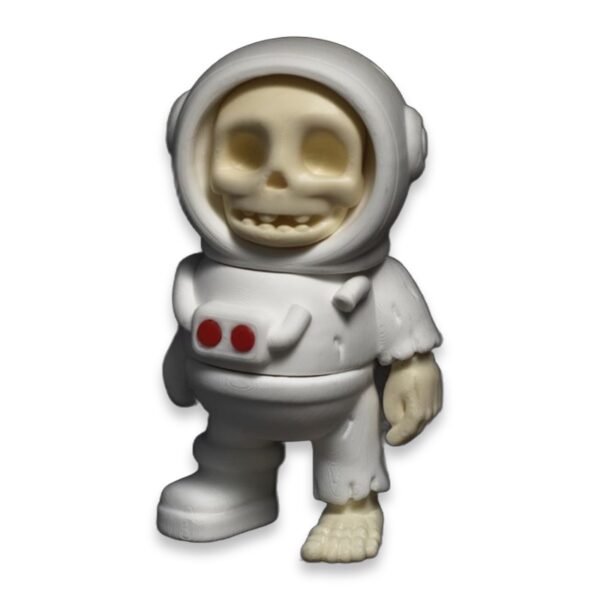 articulated-skeleton-astronaut-fidget-toy-poseable-desk-buddy-1 Front view of a white articulated astronaut figure with a grinning skeleton face visible inside the helmet and bony hands and foot showing through torn suit sleeves.