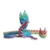 Pastel rainbow articulated dragon shown with its head detached beside the jointed body.