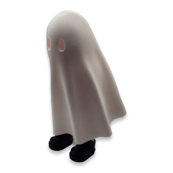 ghost-fidget-figurine-poseable-articulated-desk-buddy-2 A side view of the ghost figurine showing its flowing shape and small black feet peeking out from under the hem.