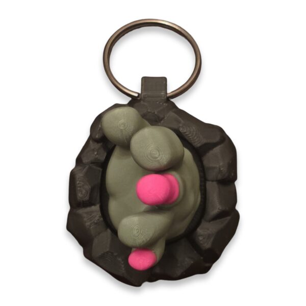 halloween-clickers-fidget-toy-clickable-3 A gray clawed hand fidget clicker keychain with pink pads, shown on a metal split ring.