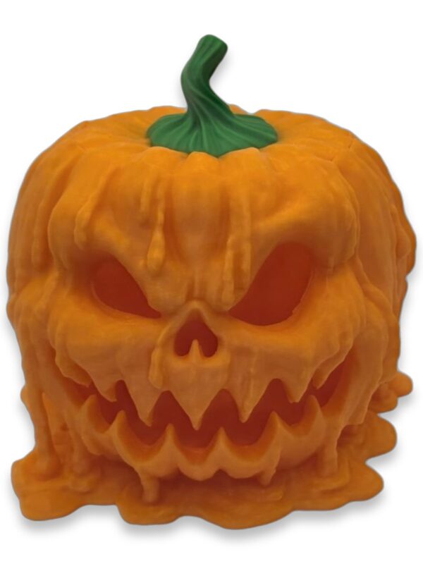 melting-pumpkin-candy-dispenser-1 Front view of an orange melting jack-o'-lantern figurine with a snarling carved face and green stem