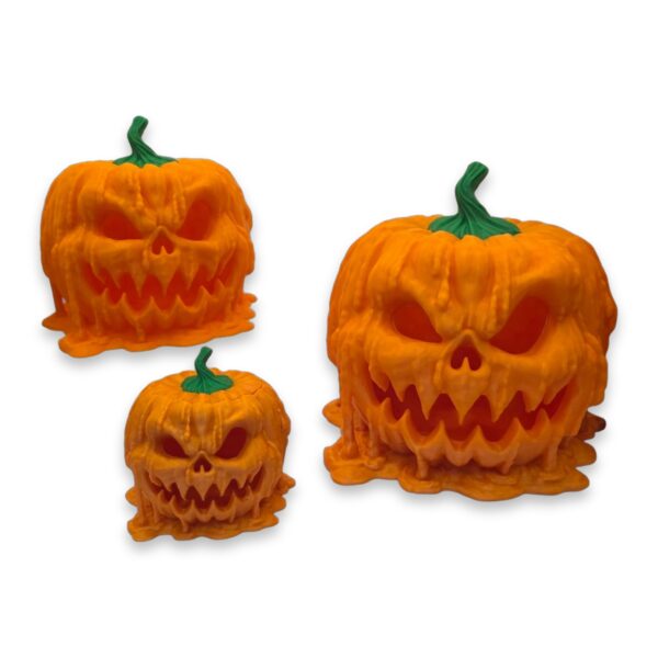 melting-pumpkin-candy-dispenser-2 Three sizes of the melting pumpkin dispenser shown side by side for scale comparison